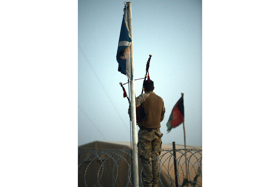 A piper playing the bagpipes at reveille