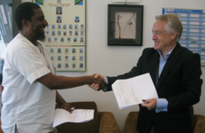 Head of DFID Tanzania, Mr Marshall Elliot shaking hands with Dr. Salim Abdulla