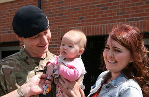 Lance Corporal Neely, his wife Rachel and their daughter are given the keys to their new home