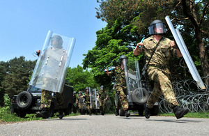 Soldiers from No 1 Company of the Irish Guards, with Perspex riot shields, helmets and batons, train to enforce public order