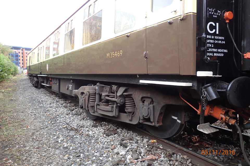 The leading brown and cream coach showing three derailed axles.