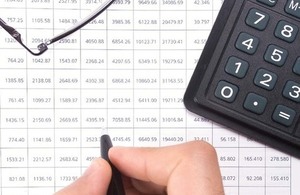 Document with rows of number and a calculator