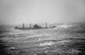 A Liberty Ship in convoy RA64 sails through heavy seas in the Arctic Ocean