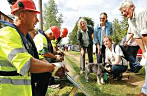Watching staff erect demountable defences