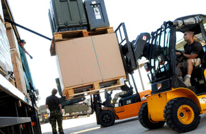 Members of the Defence Support Group unload supplies from lorries at Gioia del Colle in southern Italy