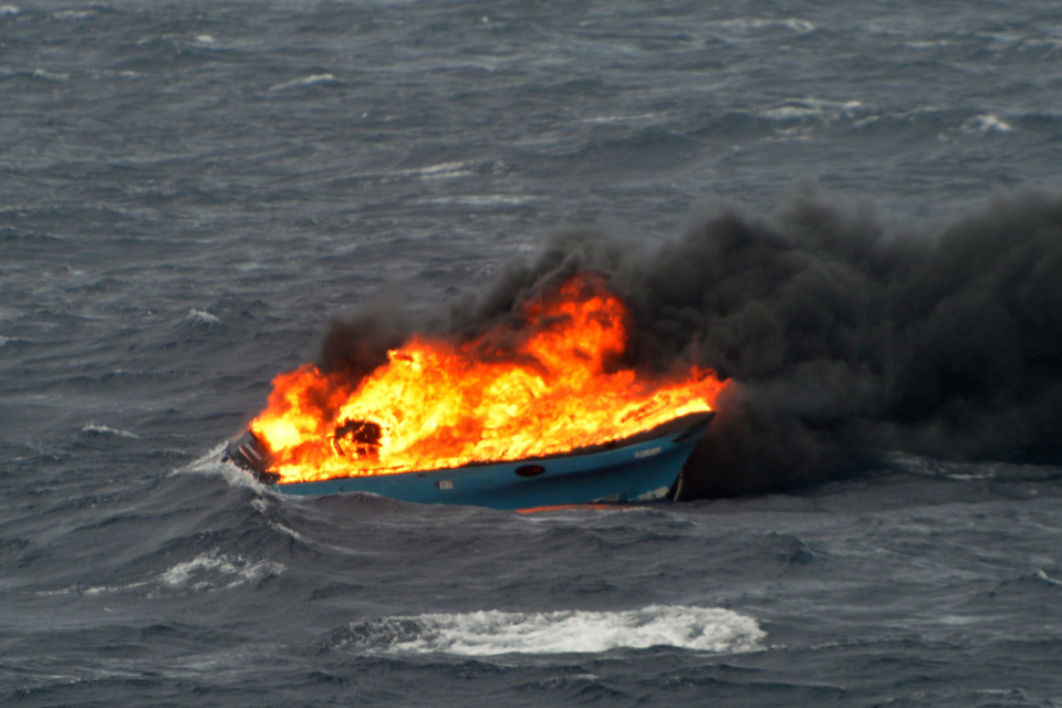 The drugs boat burns after being hit by Royal Navy gunfire [Picture: Leading Airman (Photographer) Jay Allen, Crown copyright]