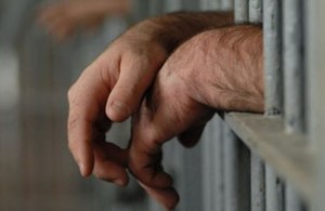 Image of prisoner behind bars