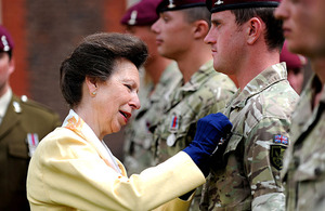 HRH The Princess Royal pins an Operational Service Medal to the chest of a soldier