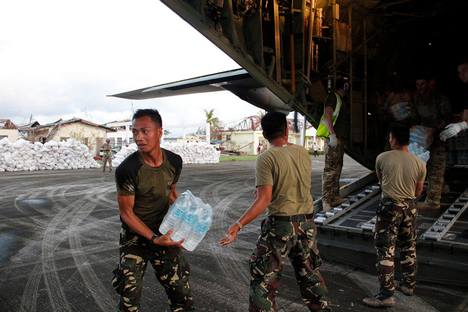 Humanitarian relief supplies are unloaded from an RAF C-130 aircraft
