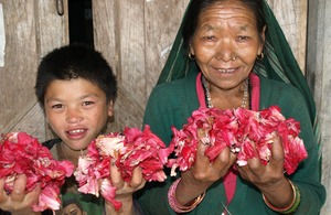 A woman and boy holidng Rhododendron flowers. Picture: Sibongile Pradhan/LFP/DFID