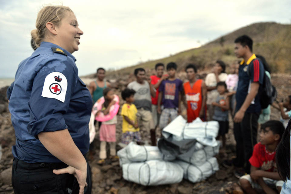 Petty Officer (Medical Assistant) Michele Trotter helps distribute prepacked shelters