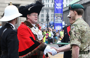 The Lord Mayor of London, Alderman David Wootton, presents a Royal Marines Reservist with his Operation HERRICK campaign medal