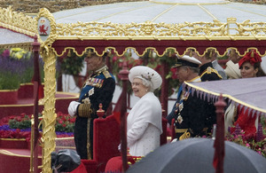 Her Majesty The Queen thoroughly enjoying the River Pageant from the Royal Barge alongside HMS President