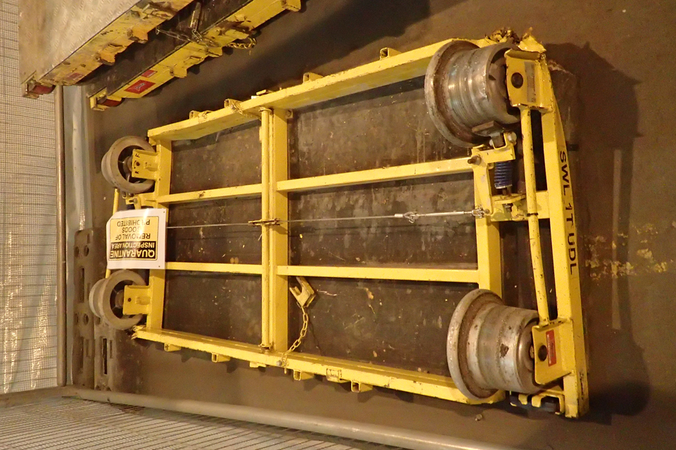 The yellow four-wheeled engineering trolley found between the Up Main line and the Down Main line with a yellow and back quarantined label
