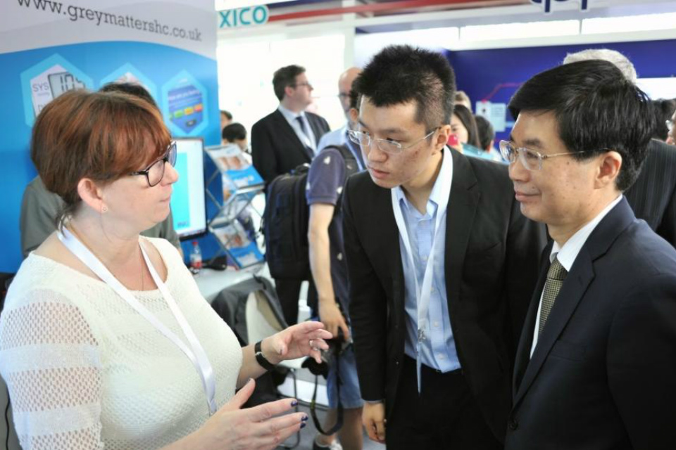 A UK participant from Grey Matters discusses her services with Chinese visitors to the demonstration centre