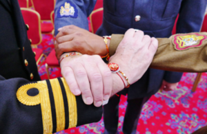 Personnel from each service with rakhis tied around their wrists.