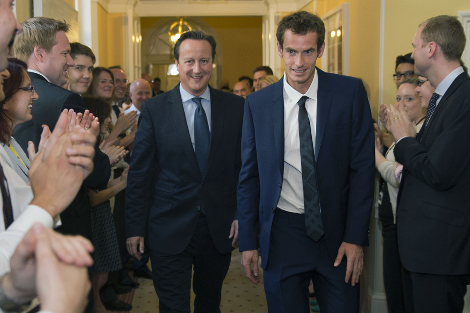 The Prime Minister leads Andy Murray through Downing Street as staff applaud