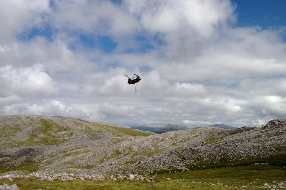 The RAF Chinook approaches the burial site