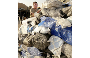 A member of the Op HERRICK Postal and Courier Squadron checks mail against a manifest at Camp Bastion in Afghanistan (stock image) [Picture: Corporal Steve Bain, Crown Copyright/MOD 2009]
