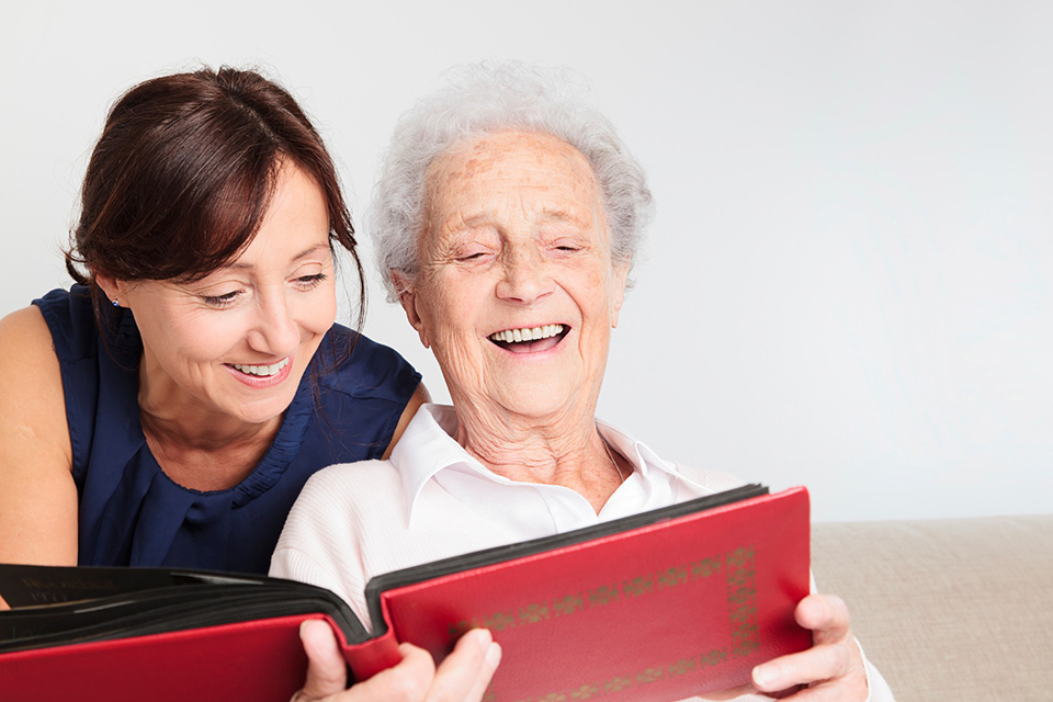 Middle aged woman and older woman with photo album