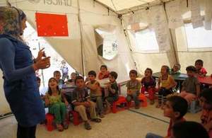 Syrian refugee children attend a lesson in a UNICEF temporary classroom in northern Lebanon, July 2014 (Picture: Russell Watkins/DFID)