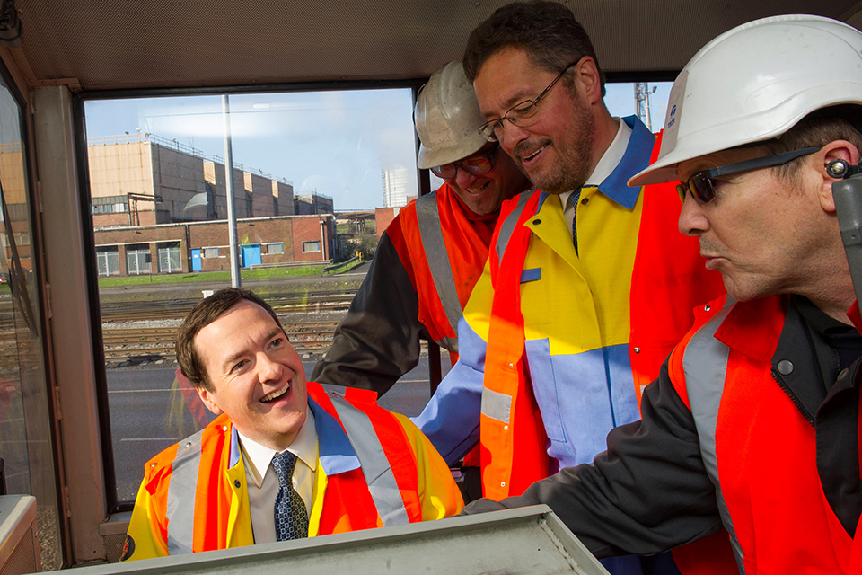 The Chancellor learns how to drive a train during his visit to the Tata steel factory in Port Talbot, South Wales. 