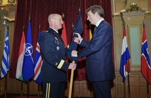 NATO General Petty handing over the NATO flag to UK Ambassador Ferguson