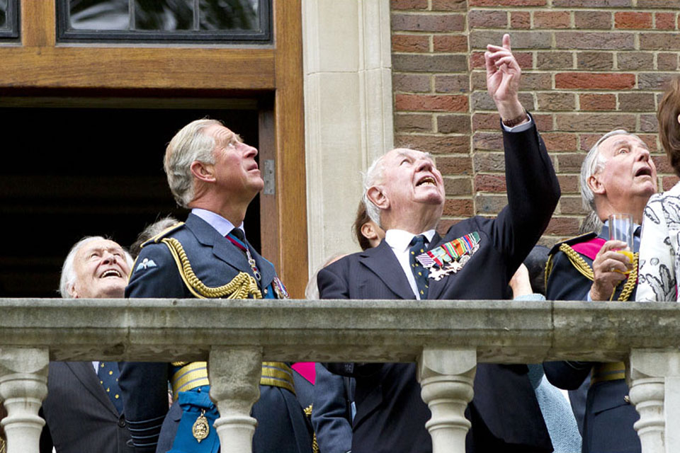 The Prince of Wales enjoying the flypast by the Battle of Britain Memorial Flight with veterans on the balcony of Church House