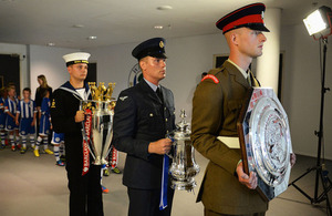 From left: Royal Navy, RAF and Army Reservists bring the Premier League, FA Cup and Community Shield trophies onto the pitch before the match [Picture: Michael Regan/The FA]