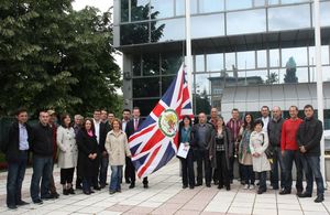 Embassy staff in front of the new Embassy building