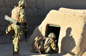 Royal Marines investigate a compound