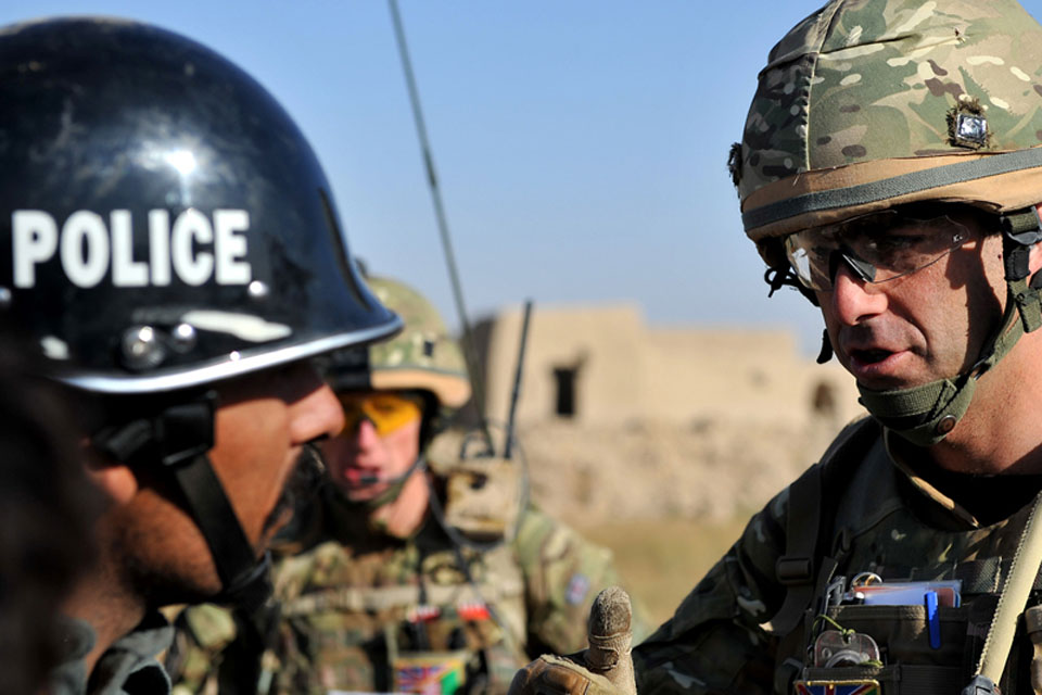 Major Nick Wight-Boycott, Officer Commanding Delta Company, 5th Battalion The Royal Regiment of Scotland, discusses the insurgent threat with an Afghan policeman