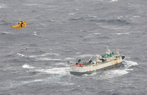 The Sea King helicopter approaches the fishing vessel at the start of the operation to airlift the critically-ill member of the crew