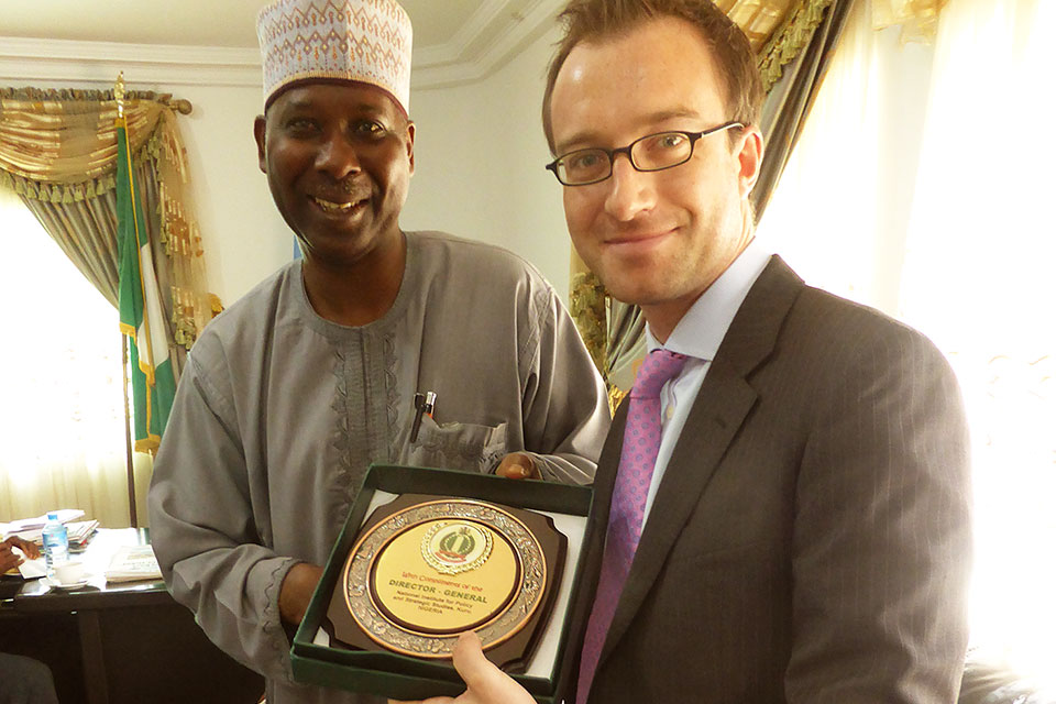 National Institute for Policy & Strategic Studies Director General, Professor Tijjani Muhammad-Bande presents a plaque to Head of Delegation, Nigel Holmes who leads on the UK political relationship with Northern Nigeria.
