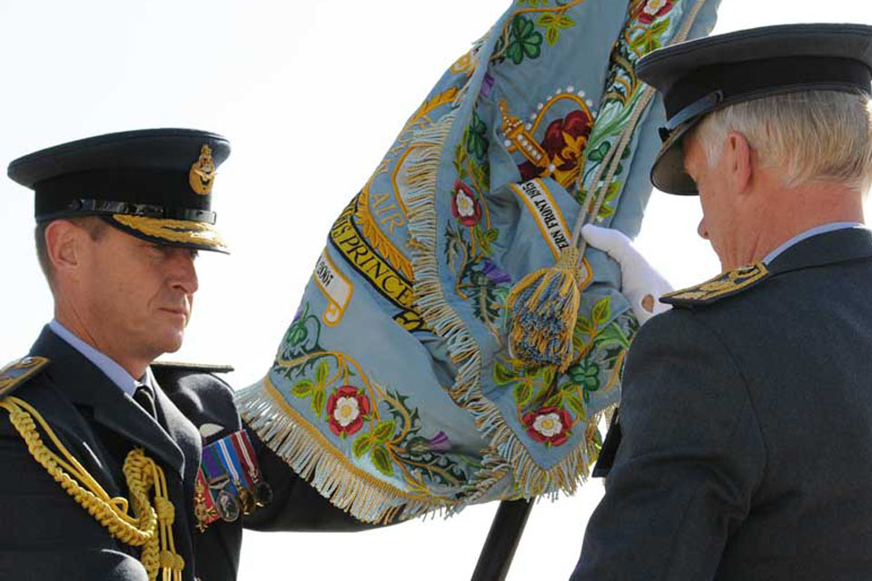 Air Officer Scotland, Air Commodore Gavin Parker, hands the 1 (Fighter) Squadron standard to Air Chief Marshal Sir Stephen Dalton