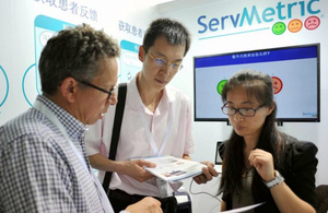 A UK participant from Servmetric discusses his services with Chinese visitors to the demonstration centre