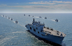 The Helicopter Carrier HMS Ocean during Exercise BALTOPS 2015. She has AH1D Apache Attack, and Wildcat helicopters on her flight deck and has ships from the 17 partner nations that took part in the exercise following behind.