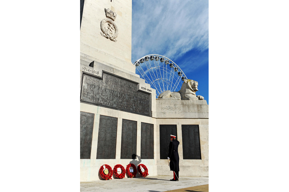 A serviceman pays his respects at the Plymouth War Memorial 
