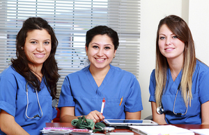 3 young female health professionals completing paperwork