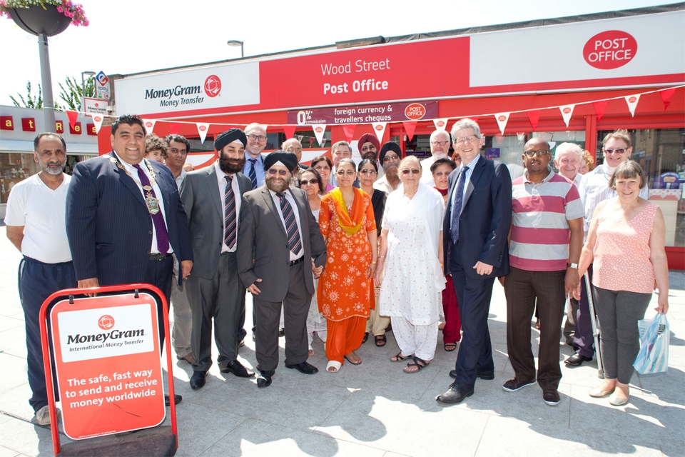 Communities Minister Don Foster with staff and customers at the Wood St Post Office, Walthamstow