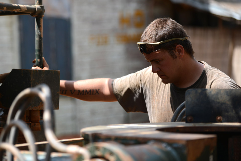 Lance Corporal Patrick Crowe examines a drill rig