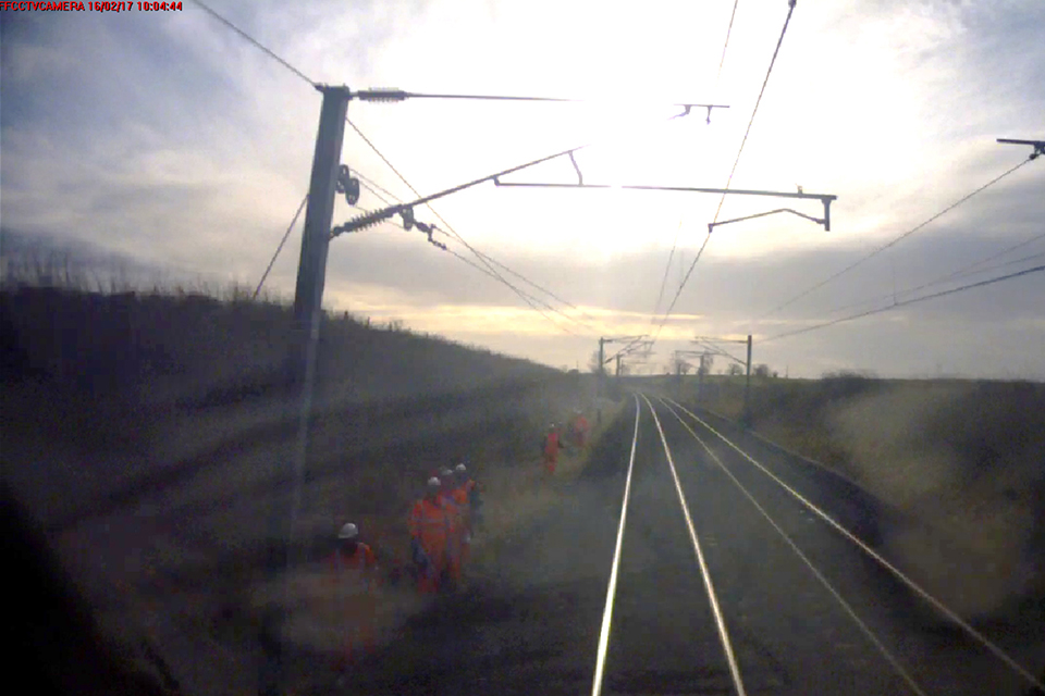 View of the group of track workers from the forward facing CCTV on the train  showing the two running lines and the overhead line equipment(photo courtesy of CrossCountry Trains)