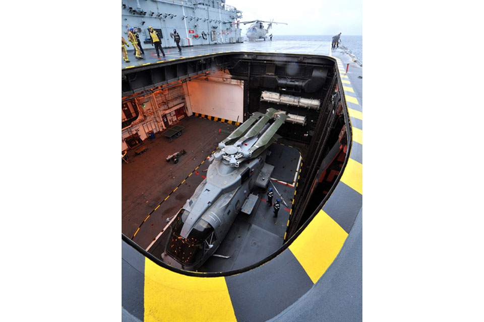 A Merlin Mk1 helicopter on the aircraft lift of RFA Argus