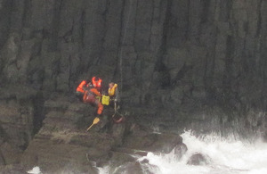 Royal Navy Search and Rescue aircrewman Petty Officer Marcus 'Wiggy' Wigfull retrieves stranded sightseers from a cliff face in the Inner Hebrides