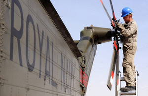 An Air Engineer maintaining the tail rotor of a Royal Navy Sea King helicopter at Camp Bastion