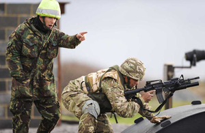 A member of the Royal Air Force Regiment instructing a member of the Tonga Defence Services at RAF Honington
