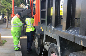 Environment Agency and DVSA staff check the details of a waste carrier