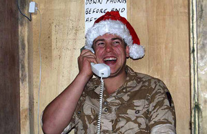 A serviceman on operations in Afghanistan takes time out to call home (stock image)