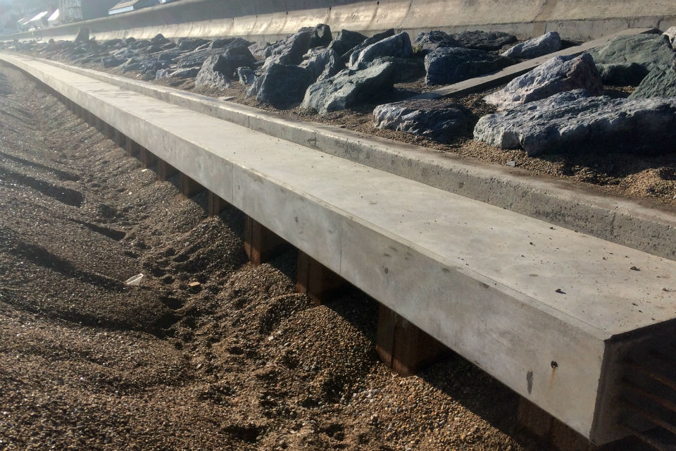 A long concrete beam sat atop a rows of pile