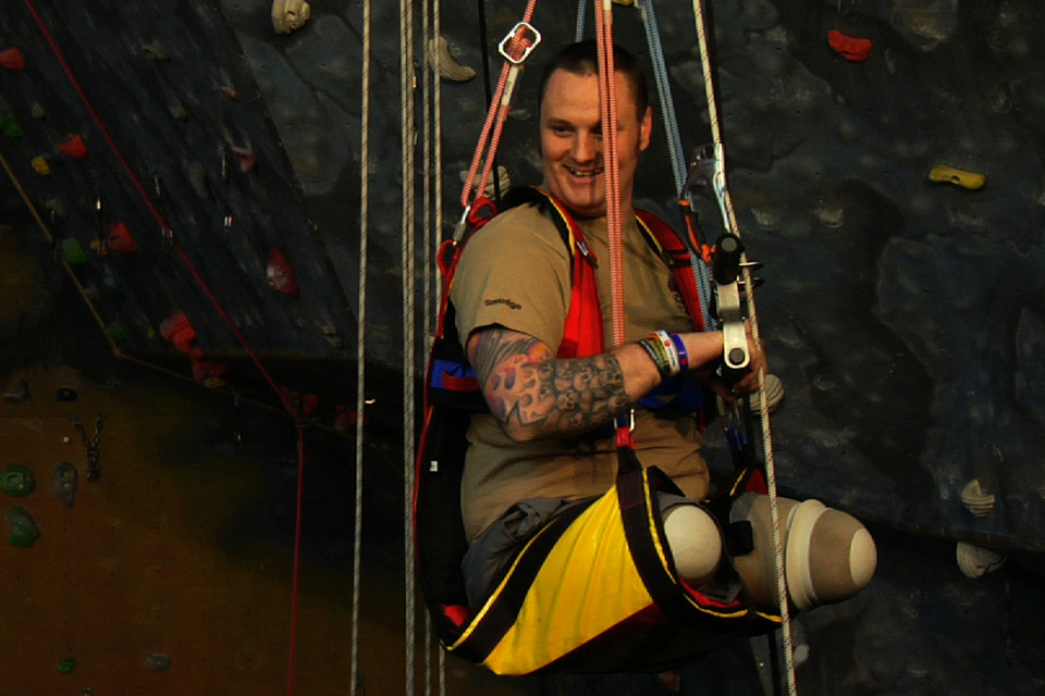 Sapper Clive Smith is hoisted onto a specially adapted climbing wall